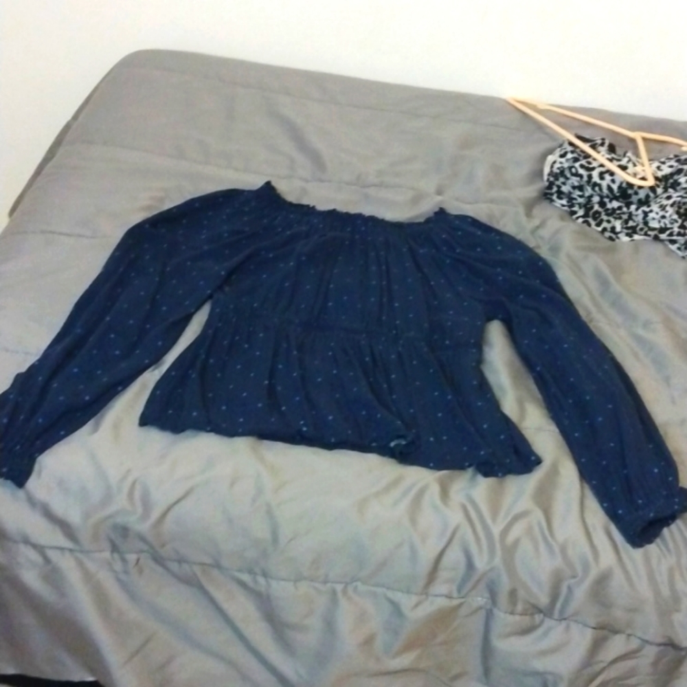 A dark blue long sleeve ruffled top with light blue dots!